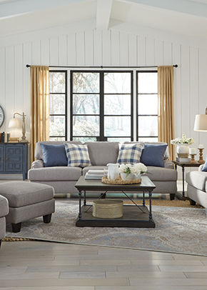 Grey sofa with blue and checkered pillows